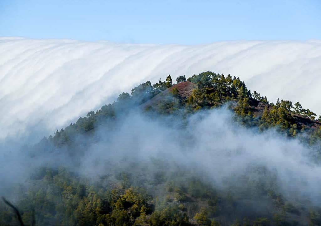 Cloud waterfall phenomenon in La Palma. La Palma - The Hidden Gem of the Canary Islands, article by Kiss My Backpack at https://www.kissmybackpack.com/