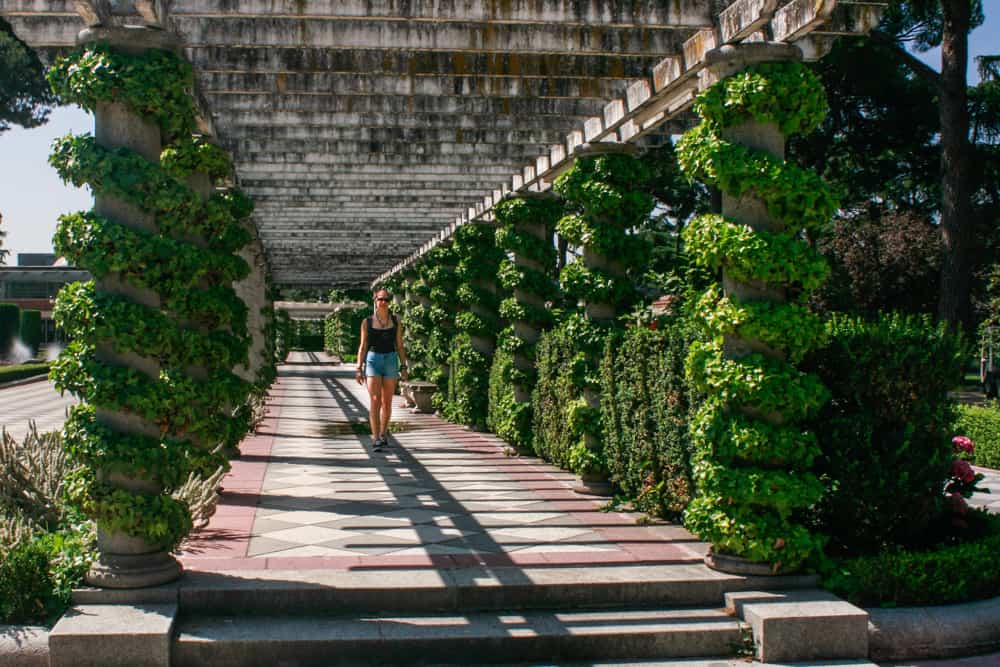 A travelling girl walking under the shadow in El Retiro Park, Madrid, Spain