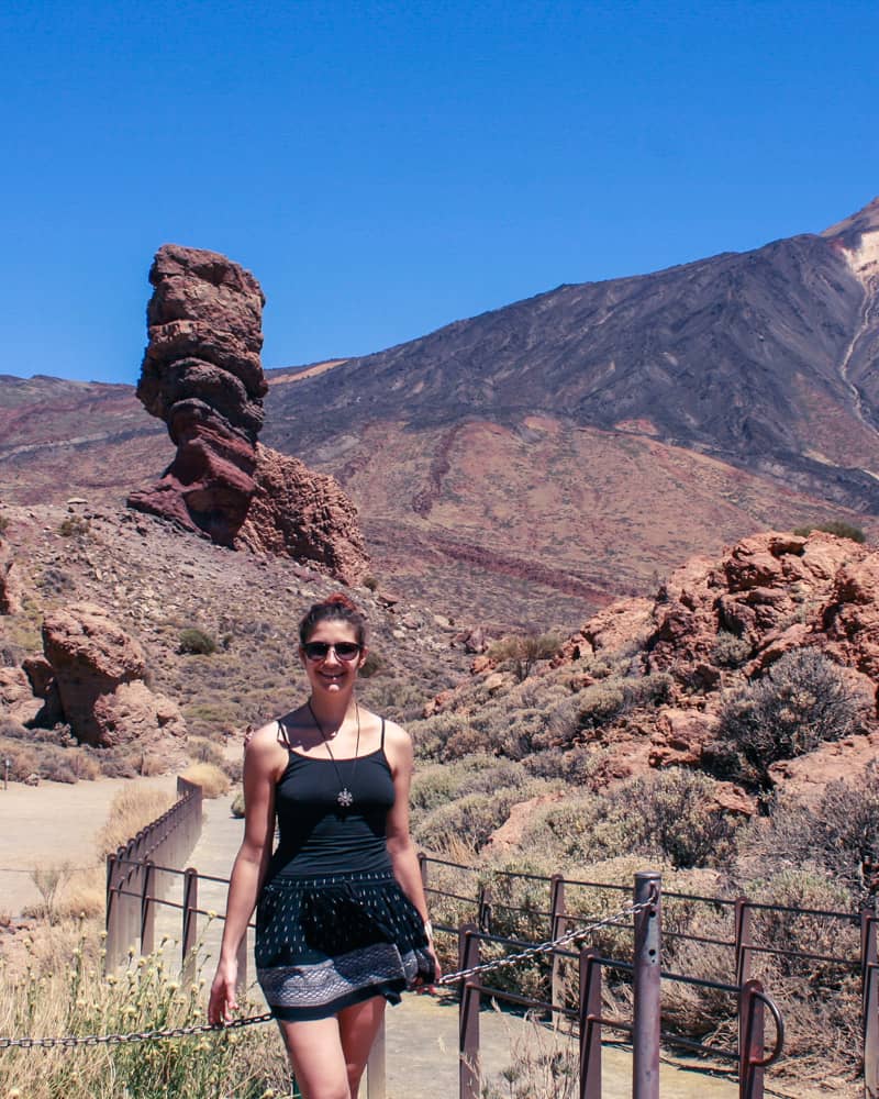 A girl in front of rock formations Los Roques de Garcia and the Volcano El Teide in Tenerife, Canary Islands, Spain