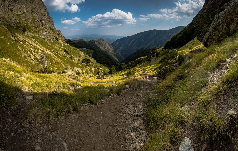 Panorama of what is seen from the waterfall - path, mountains, cliffs, sky