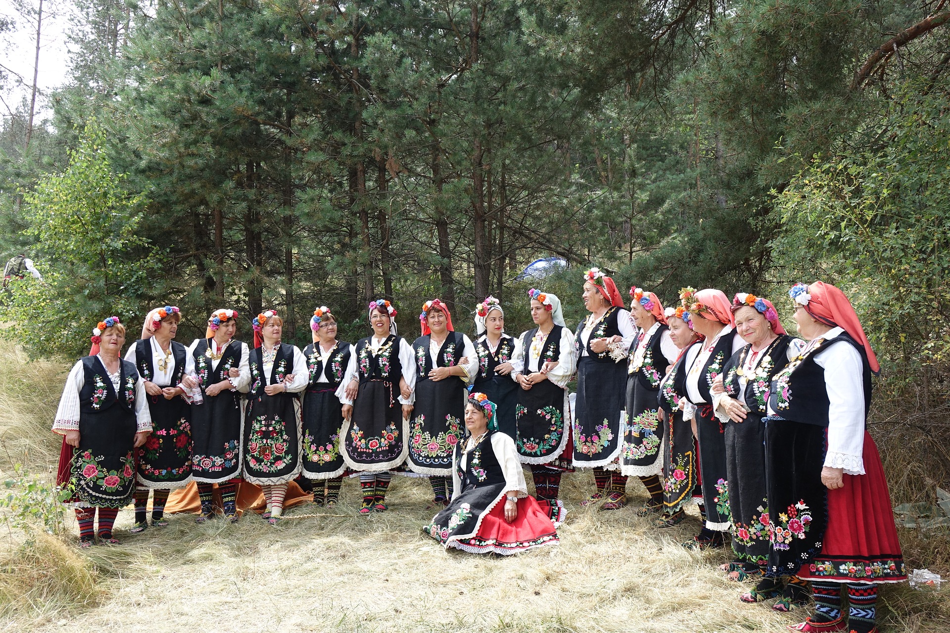 Bulgarian women dressed in traditional dresses in the forest