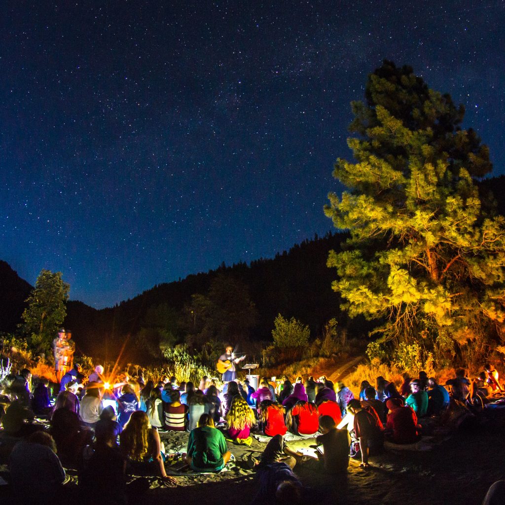 Outdoor festival under the open sky, firepit under the trees