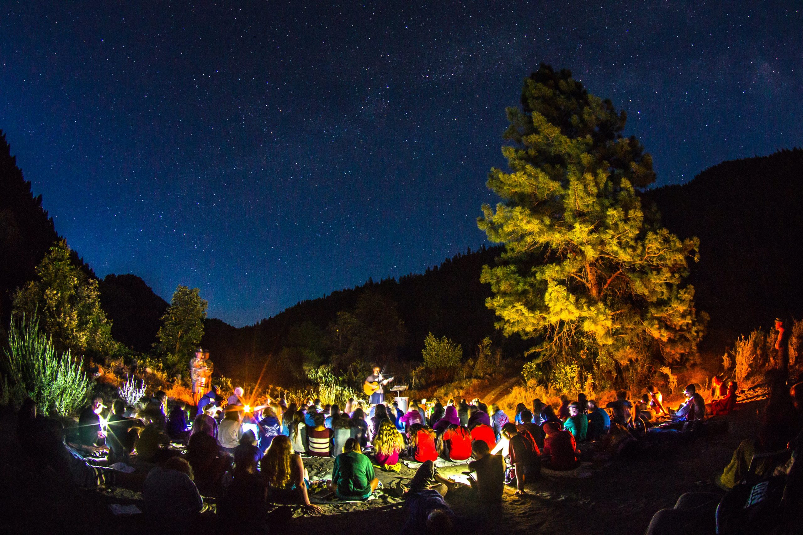 Outdoor festival under the open sky, firepit under the trees