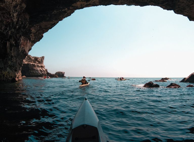 A kayak nose looking towards the Black Sea from the inside of a cave in Tyulenovo