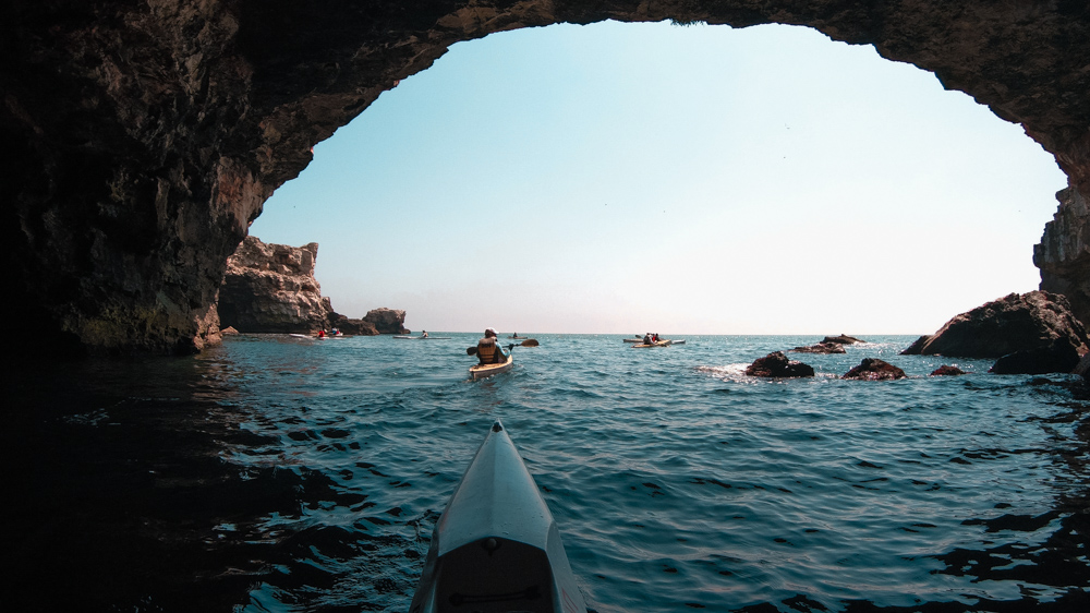 A kayak nose looking towards the Black Sea from the inside of a cave in Tyulenovo