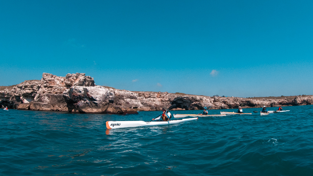 Three kayaks in the Black Sea in front of cliffs in Bulgaria