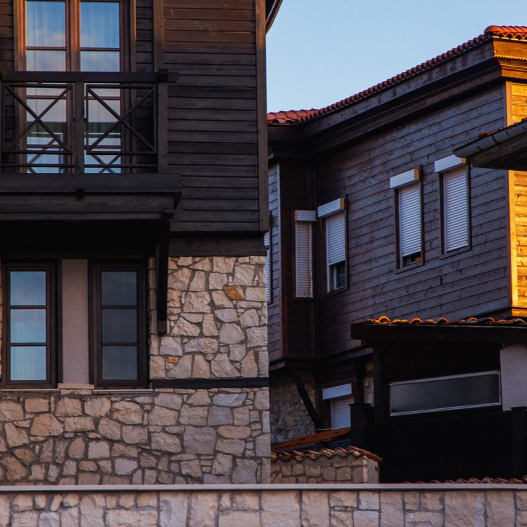 wood and stone black sea style houses during sunset