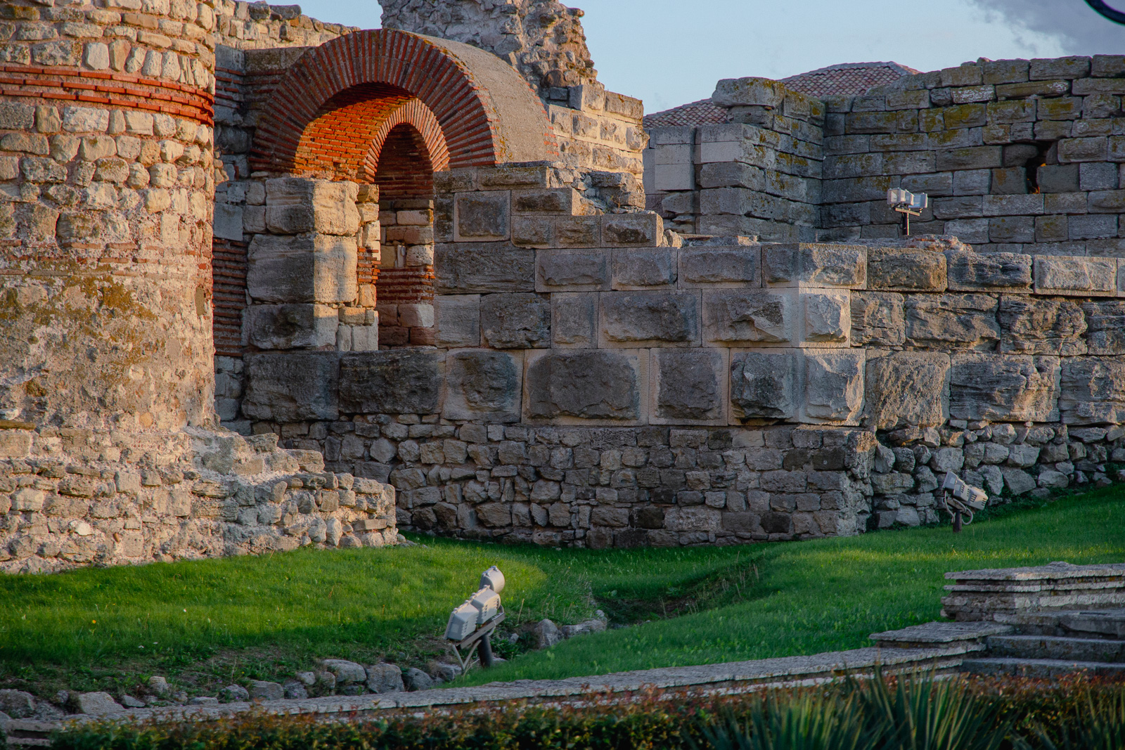 Preserved parts of the western wall with green grass in front