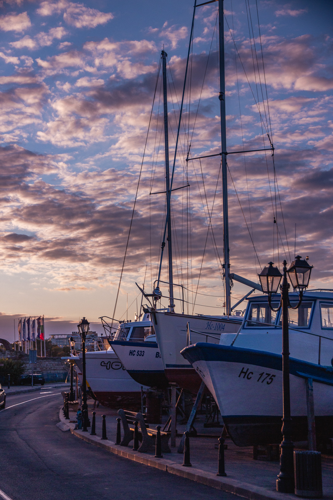 Tall yachts in Nessebar port during sunset