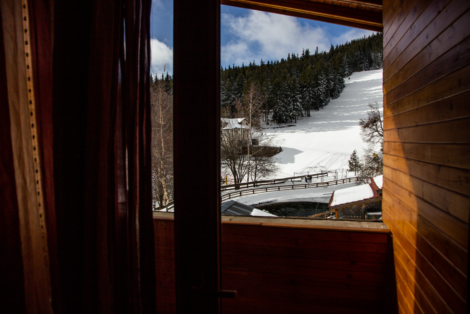 view towards snowy Osogovo ski slope from a hut balcony