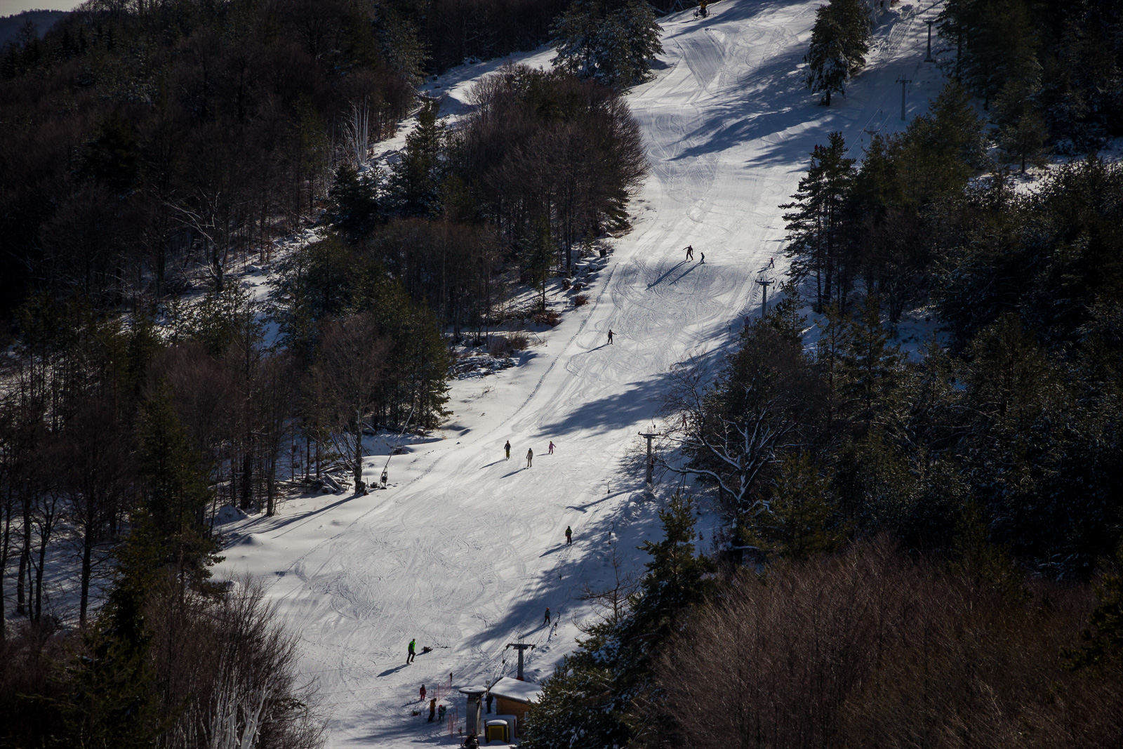 Close up of ski slope Plaviloto and people skiing
