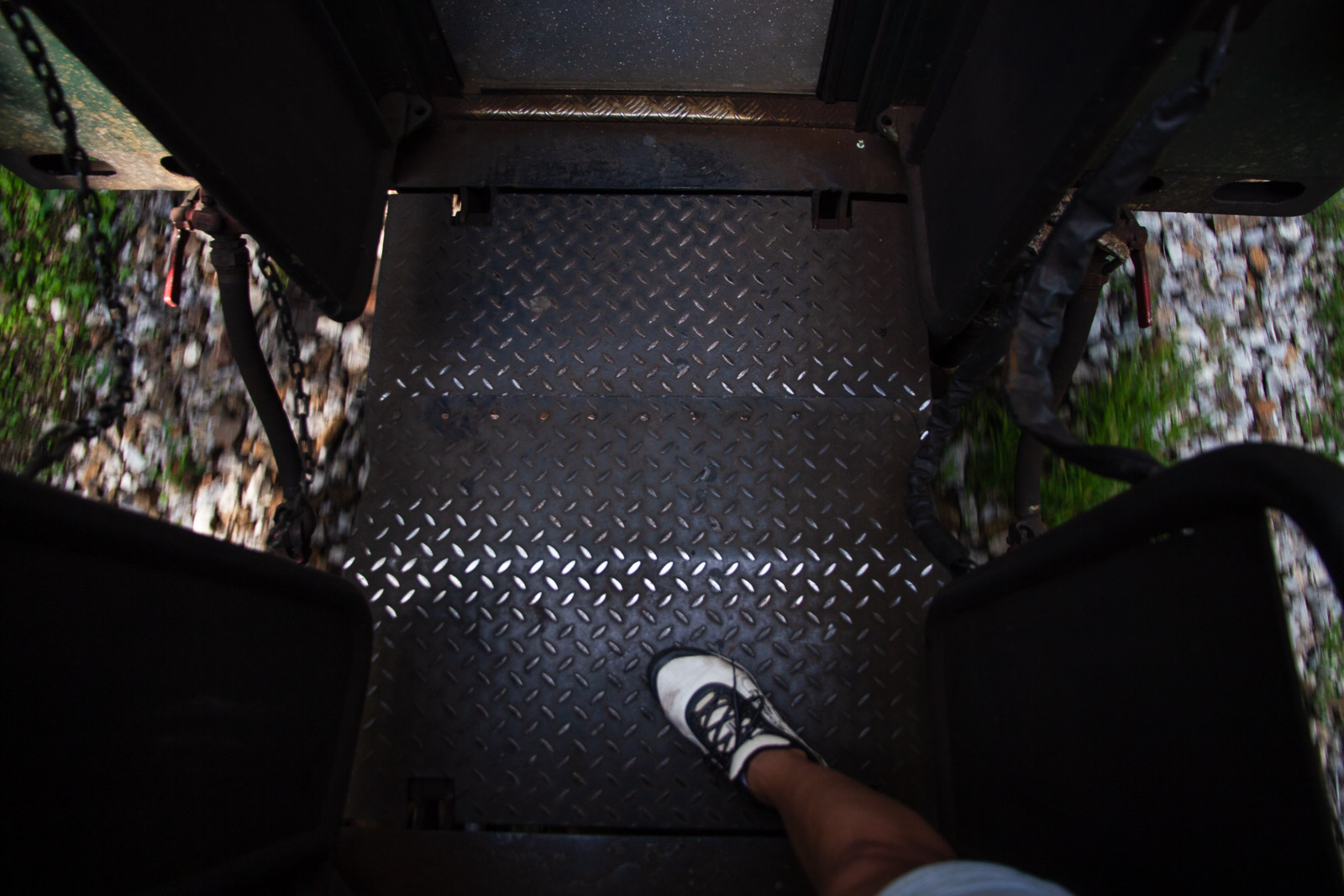 Leg walking through a train with open sides