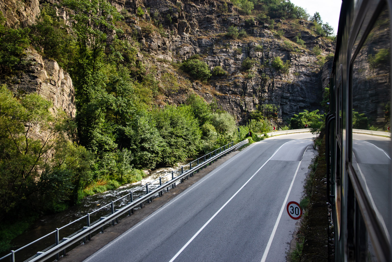 View towards cliffs and a river from a train