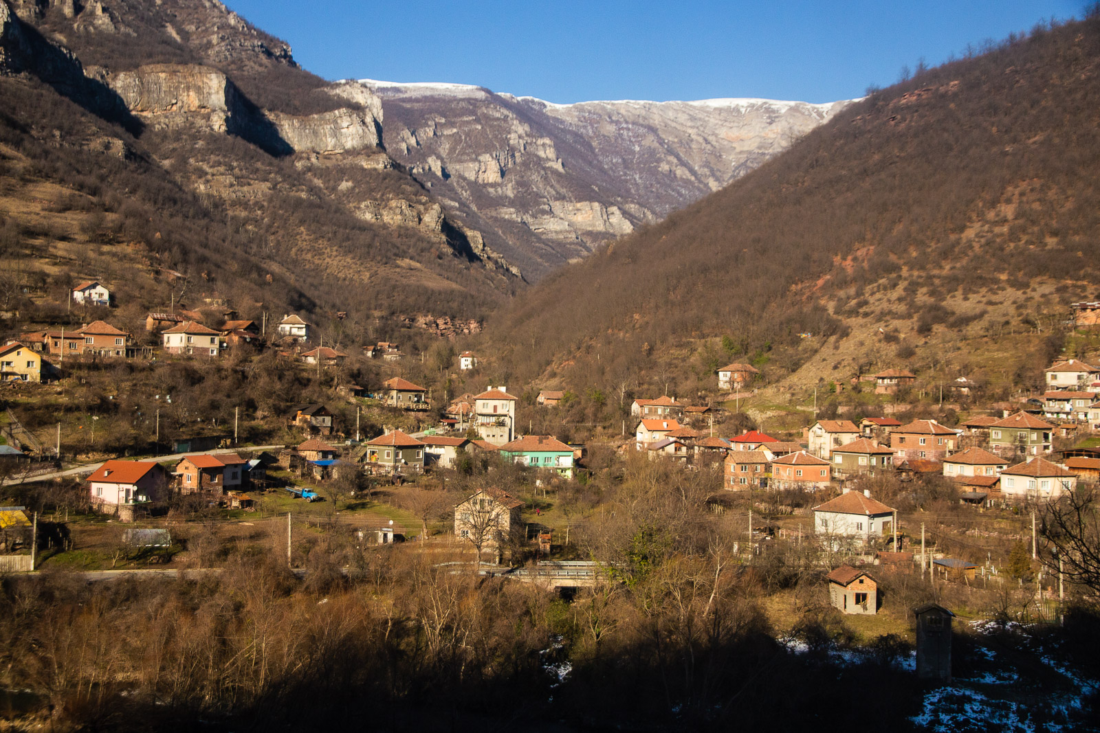 Panoramic view towards mountain villages from a train in Bulgaria