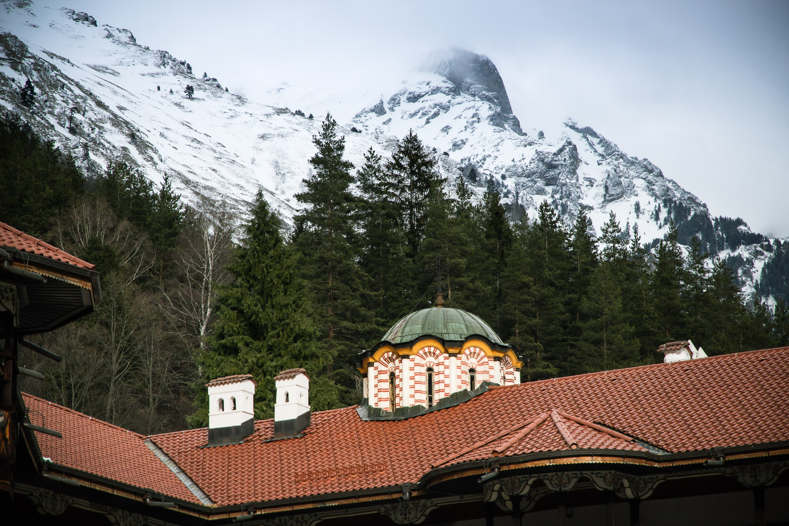Snowy mountains behind monastery rooftops