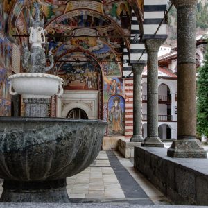 fountain and frescoes in rila monastery