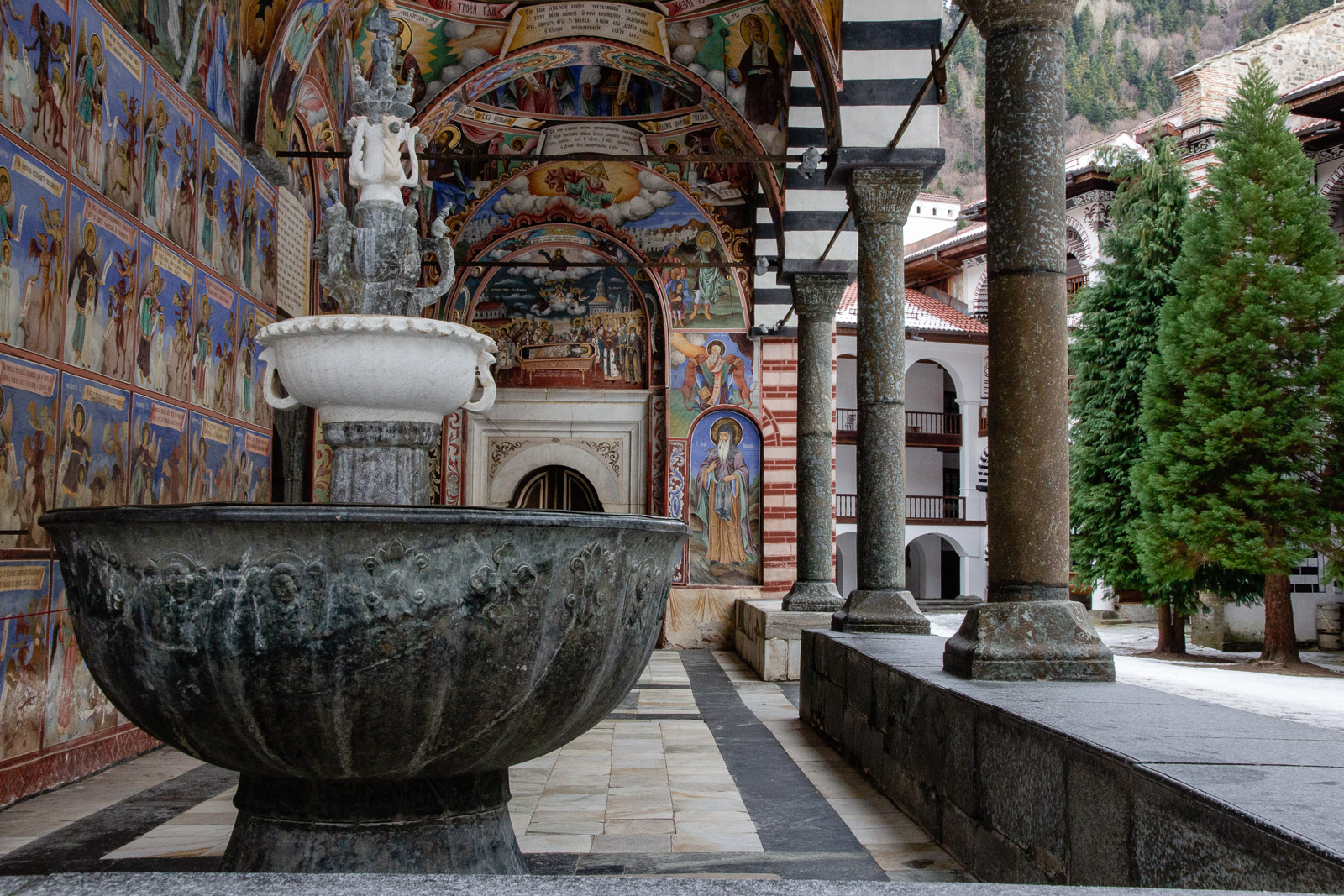 fountain and frescoes in rila monastery
