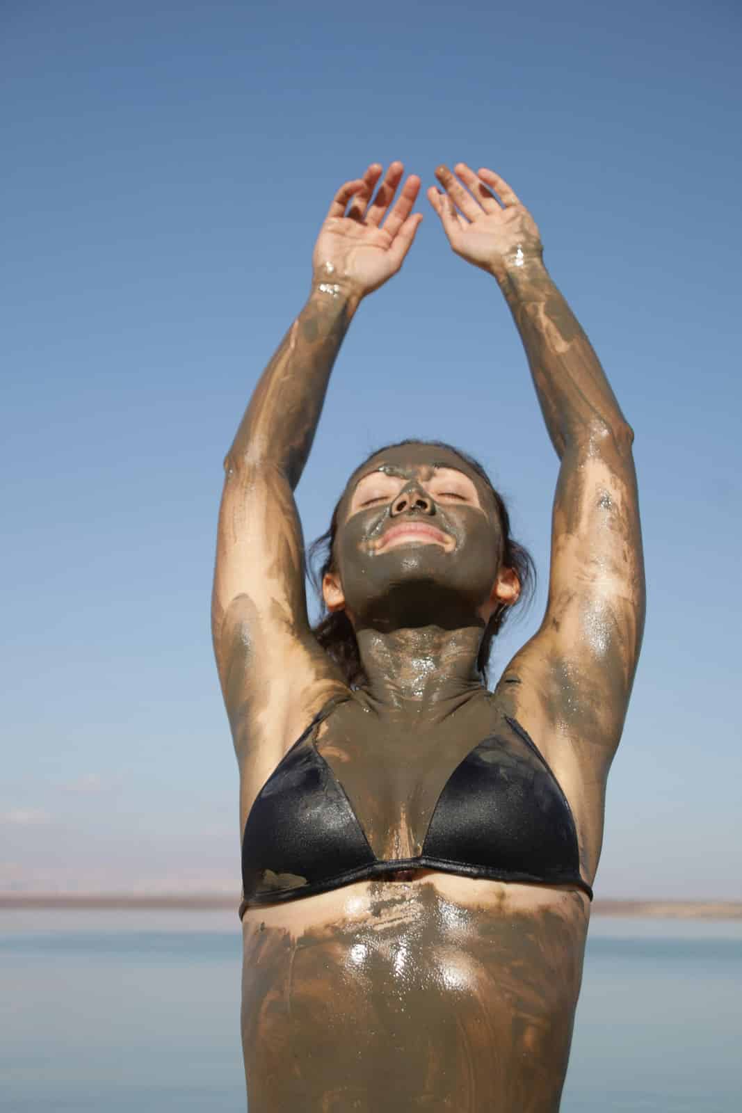 woman taking a mudbath in the sun