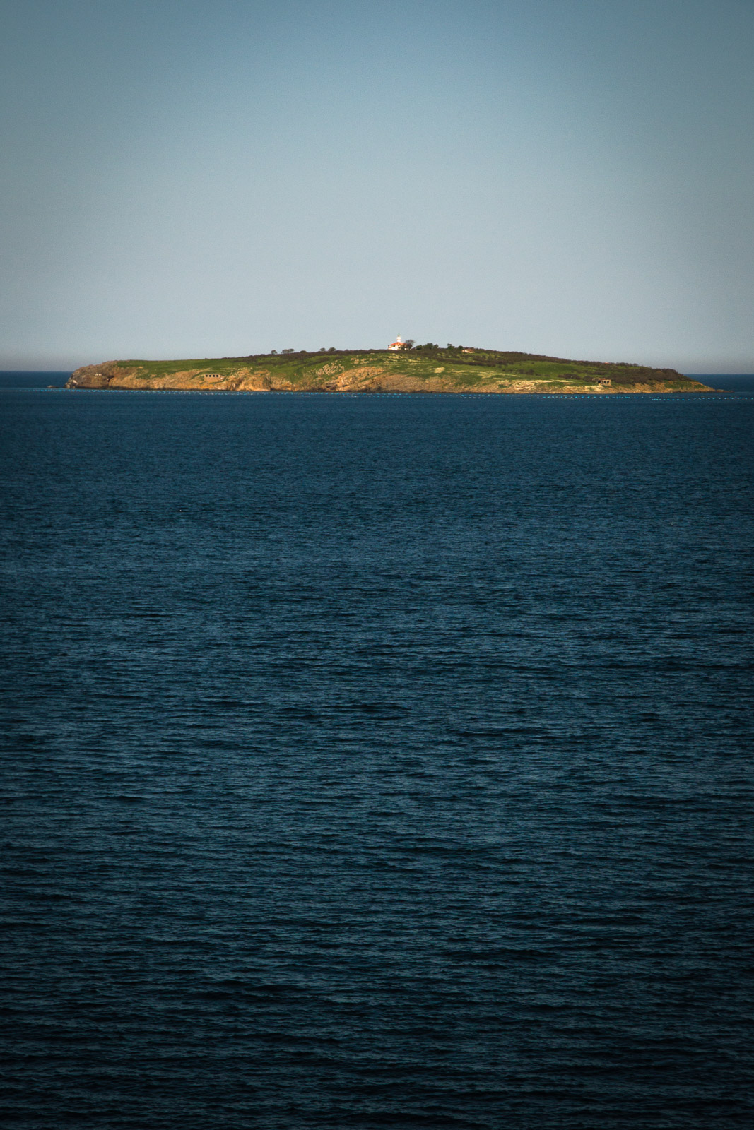 vast sea with a nearby island with a church