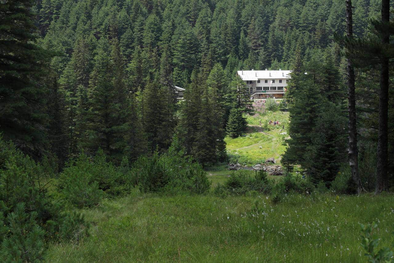 Skakavitsa hut in the forest as seen from a distance